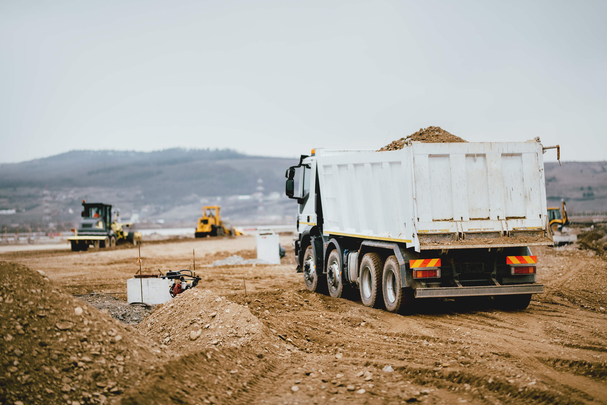 Dump trucks working on a paving jobsite